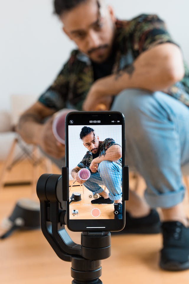 How to Build a Professional Mobile Studio for under KSh 5,000 3 Content creator using a phone tripod mount for business video